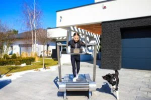 the girl walks on an outdoor treadmill